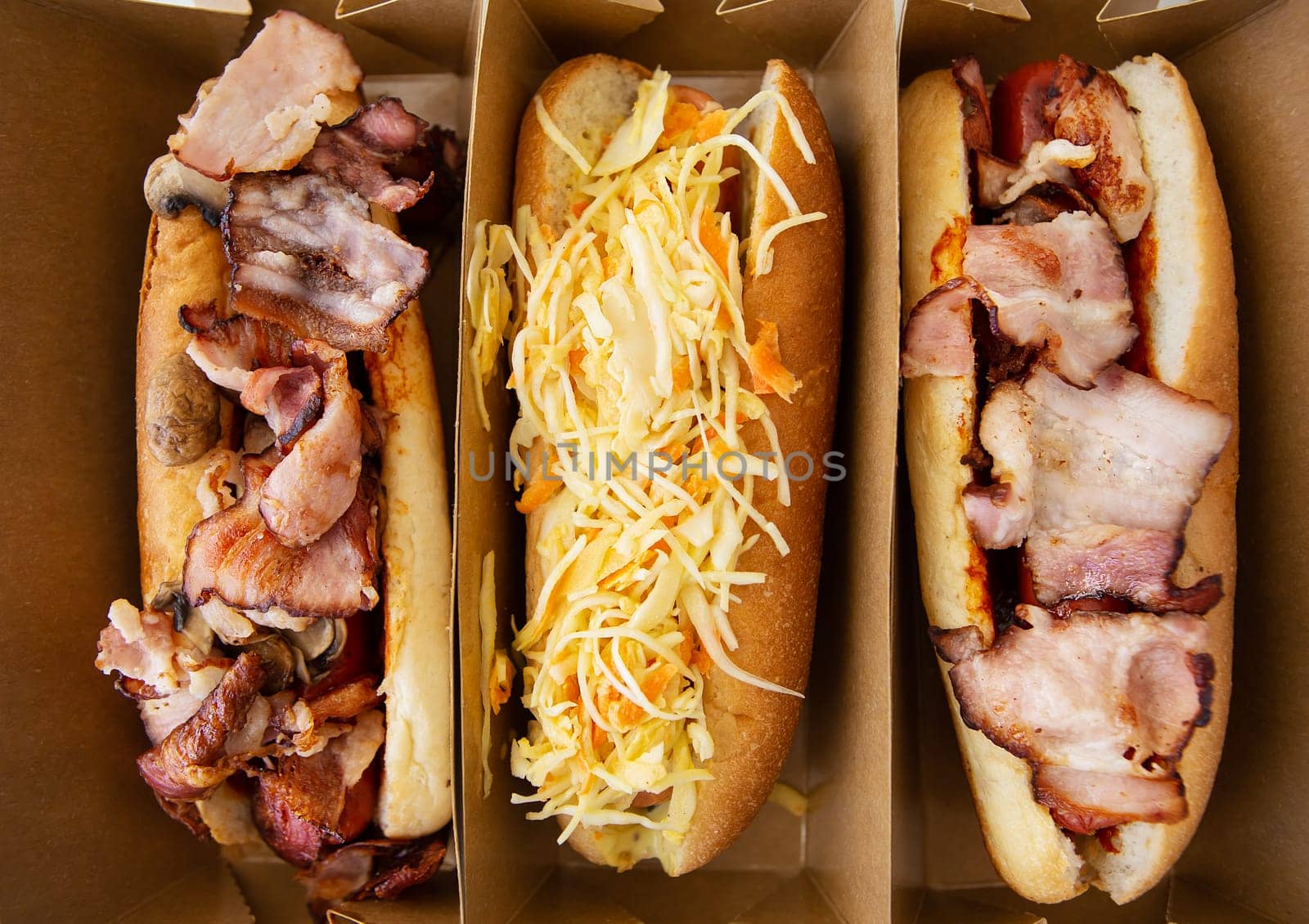American hot dog with different flavors, with cheese and crispy onions on a white table in a minimalist style. Fast food, takeaway food, food for motorists. Hot dog sandwich with sausage. by sfinks