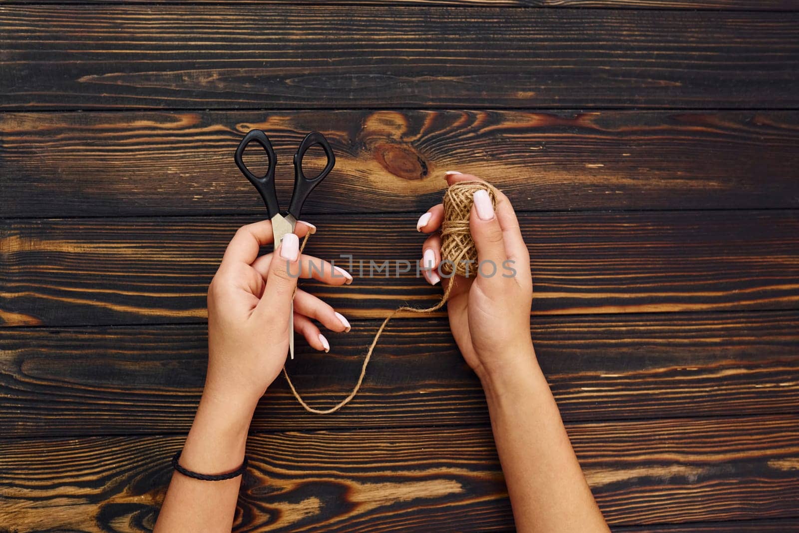 Woman's hands holds toys. Top view of christmas festive texture with new year decorations by Standret