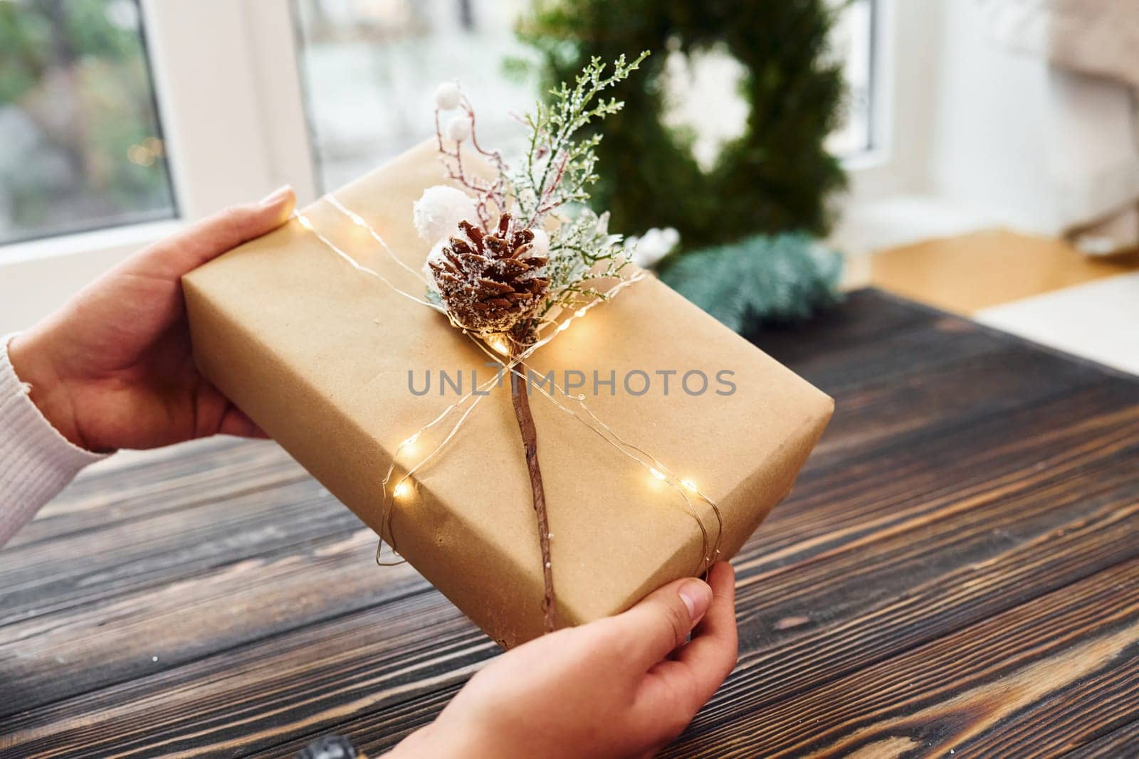 Woman holds gift box. Top view of christmas festive texture with new year decorations.