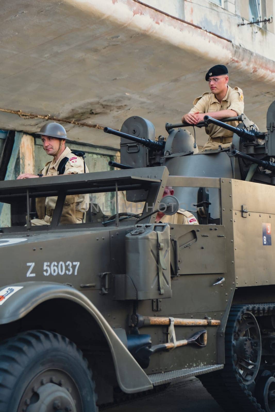 Hel, Poland - August 2022 Military troops marching during 3 May Polish Constitution Day ceremonial patriotic parade. Polish armed forces tanker military parade. Old guns and cars. Feast of Polish Armed Forces Day, American soldiers with US flag on parade Nato Vehicles Military Equipment