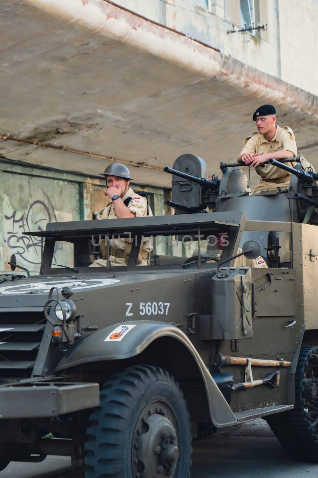 Hel, Poland - August 2022 Military troops marching during 3 May Polish Constitution Day ceremonial patriotic parade. Polish armed forces tanker military parade. Old guns and cars. Feast of Polish Armed Forces Day, American soldiers with US flag on parade Nato Vehicles Military Equipment