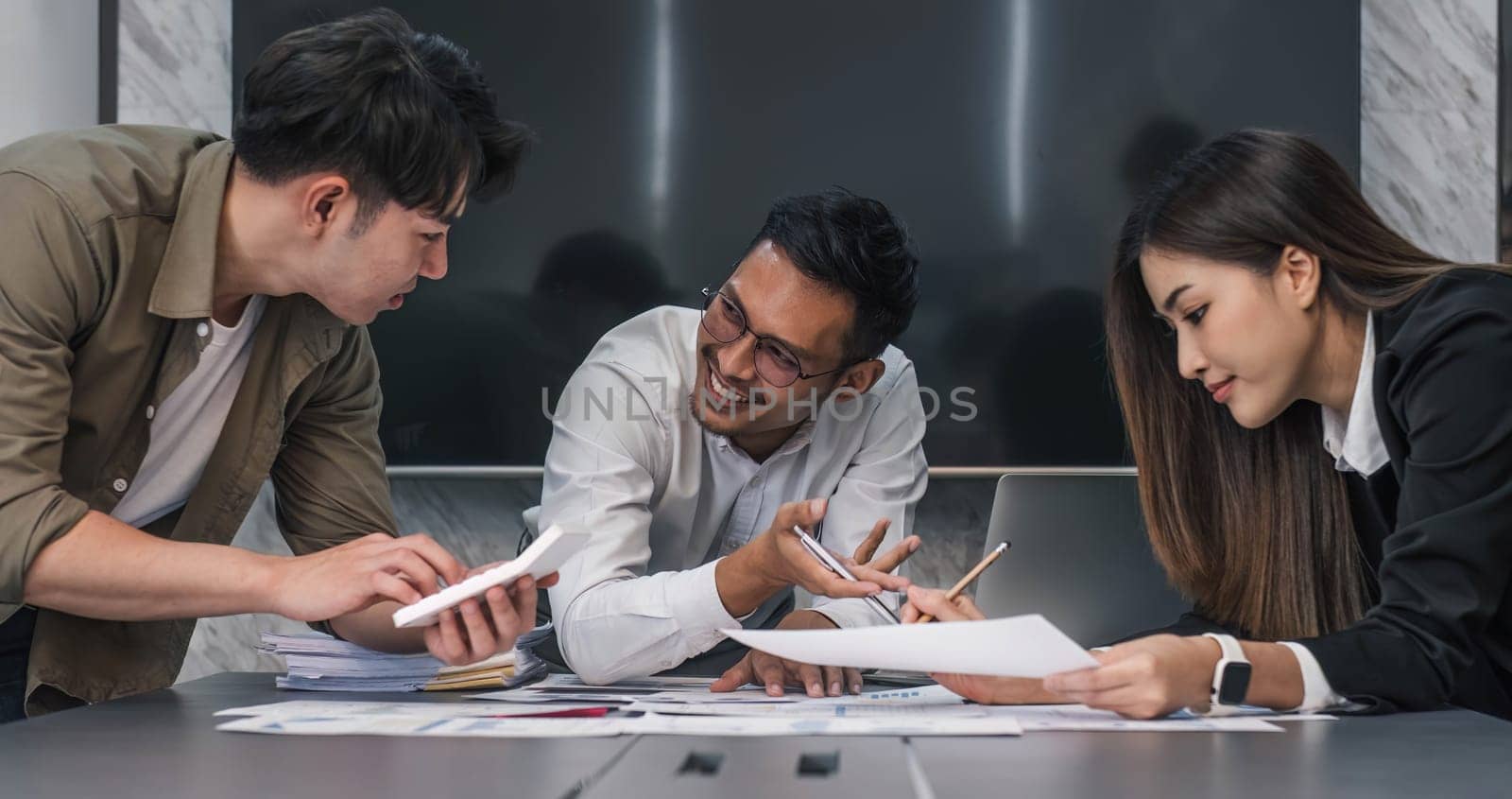 Business People Meeting using laptop computer,calculator,notebook,stock market chart paper for analysis Plans to improve quality next month. Conference Discussion Corporate Concept