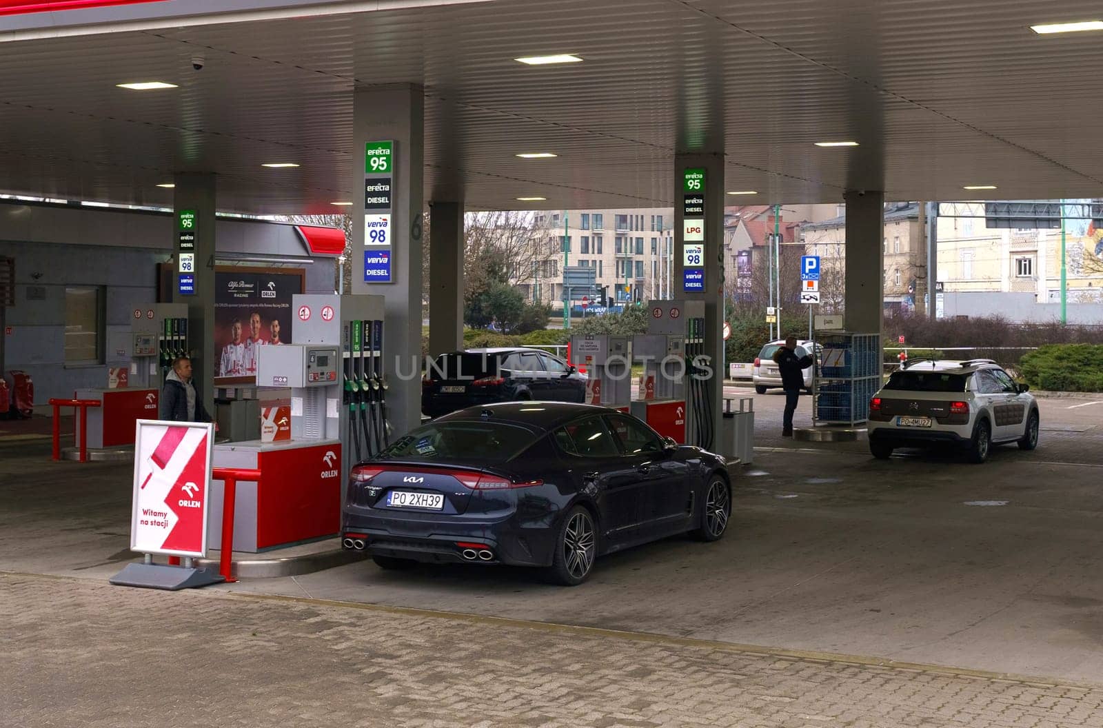 Poznan, Poland - February 11, 2023: Refueling cars at a gas station in the city.