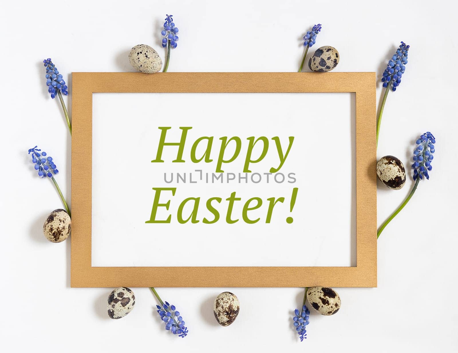 Easter composition with paper blank with text Happy easter, quail eggs, fresh flowers and golden frame. Top view, flat lay by Ri6ka