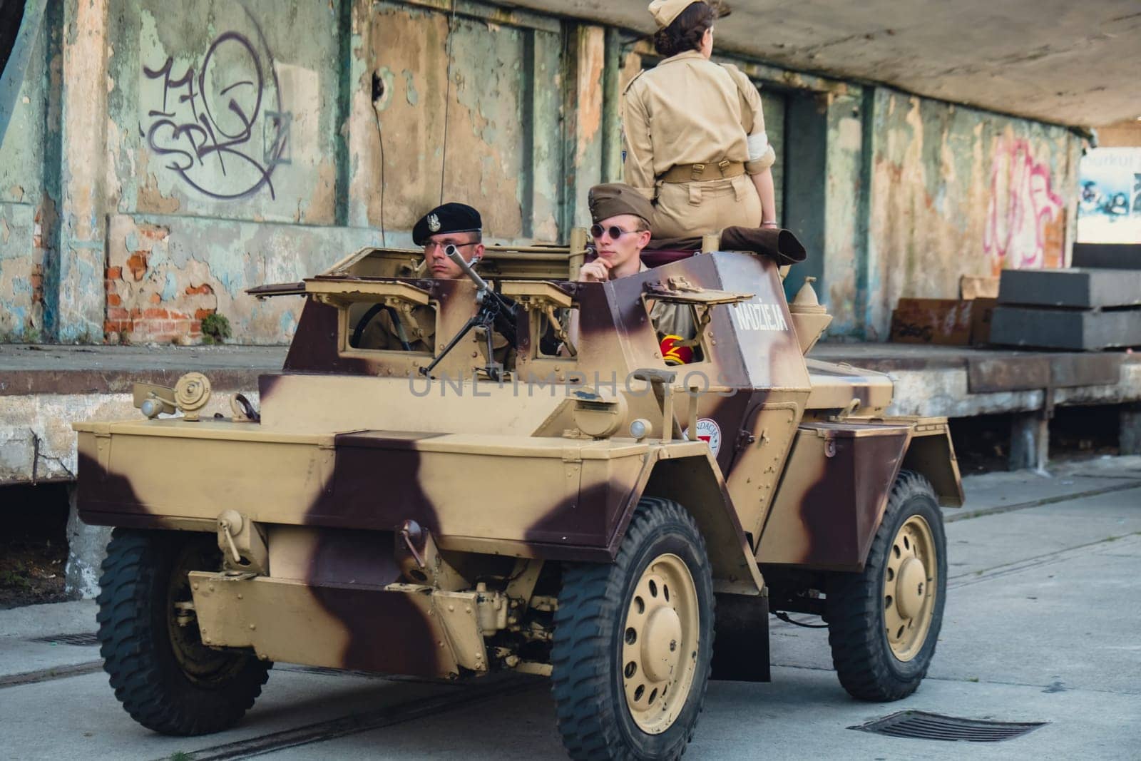 Hel, Poland - August 2022 Military troops marching during 3 May Polish Constitution Day ceremonial patriotic parade. Polish armed forces tanker military parade. Old guns and cars. Feast of Polish Armed Forces Day, American soldiers with US flag on parade Nato Vehicles Military Equipment