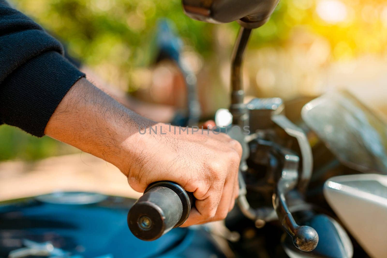 Hands of man on the motorcycle handlebars. Motorbike speeding concept, Hands of a motorcyclist on the handlebars. Close up of the hands on the handlebars of a motorcycle by isaiphoto