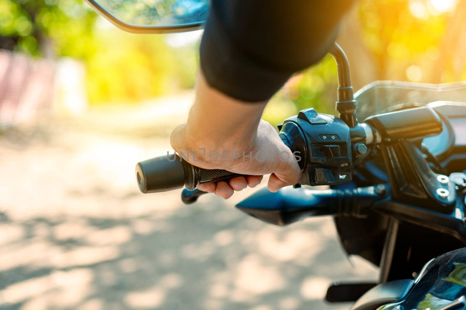 Hands of a motorcyclist on the handlebars, Close up of the hands on the handlebars of a motorcycle. Hands of a person on the motorcycle handlebars. Motorbike speeding concept by isaiphoto