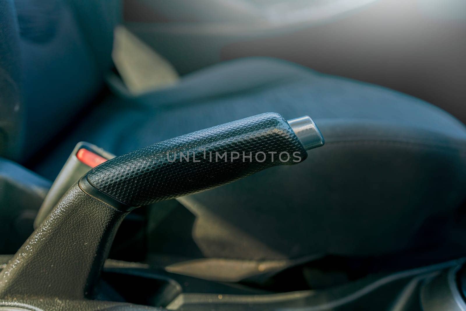 Handbrake of a car. Close up of the parking brake of a car. Car emergency brake close-up