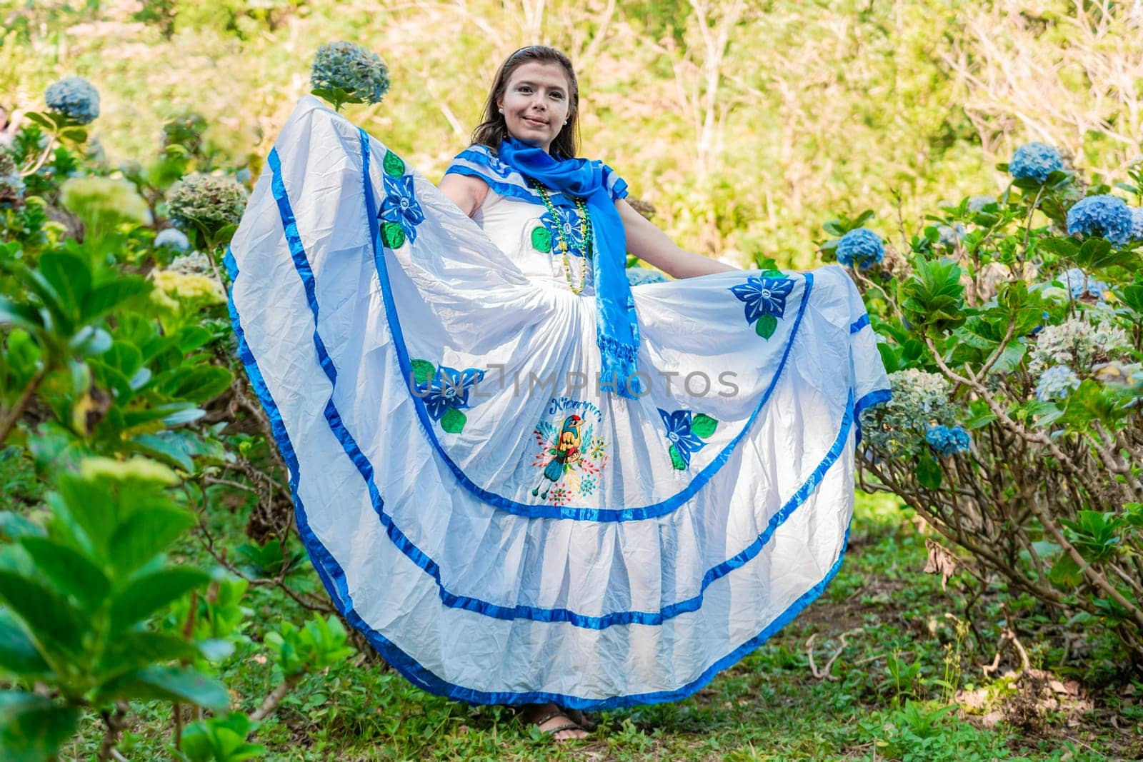 People in Nicaraguan national folk costume. Young Nicaraguan woman in traditional folk costume in a field of Milflores, Smiling woman in national folk costume in a field surrounded by flowers