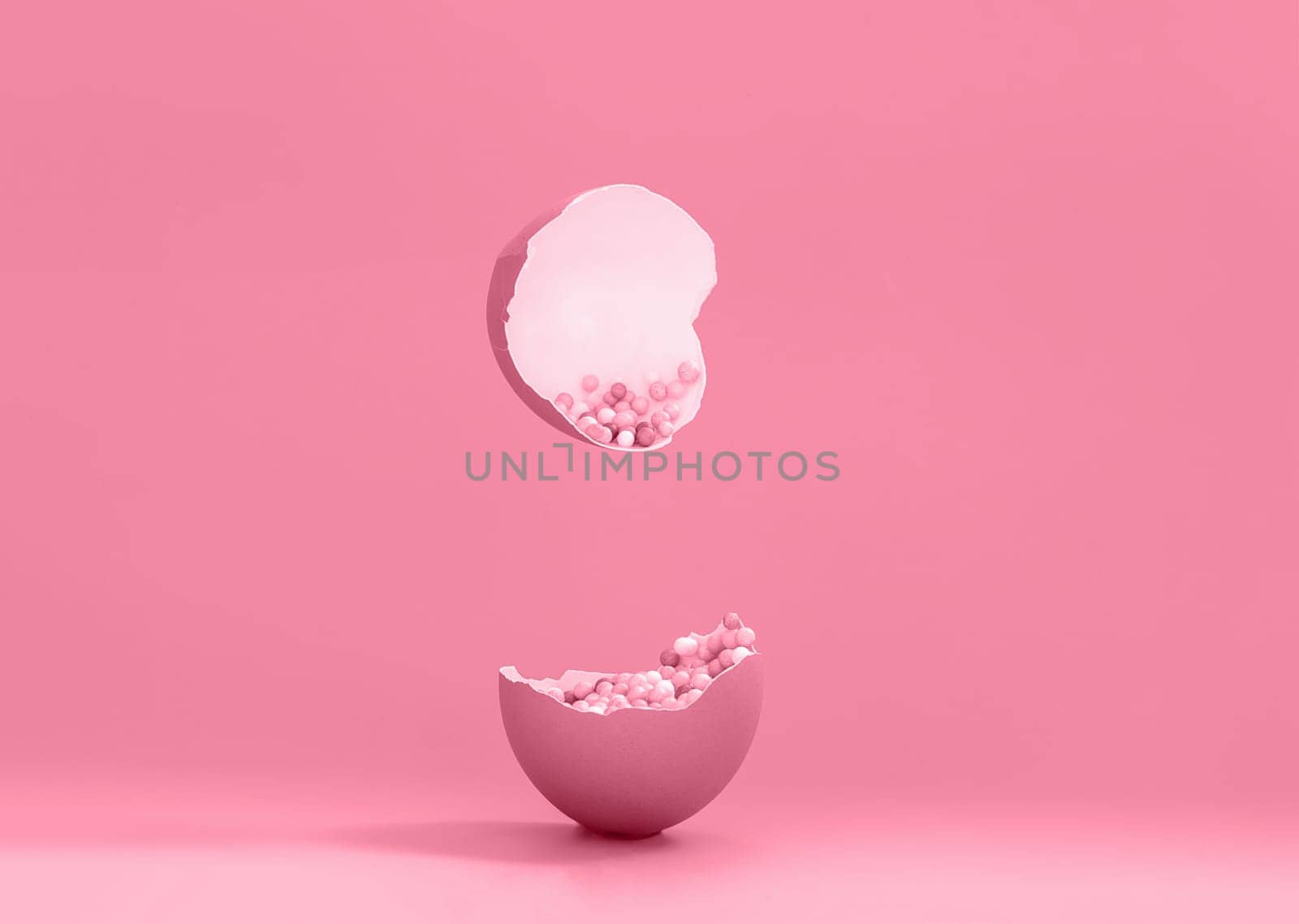 Broken decorative easter egg with colorful confetti. Minimal composition, monochromatic color pastel pink background. Space for text by Ri6ka