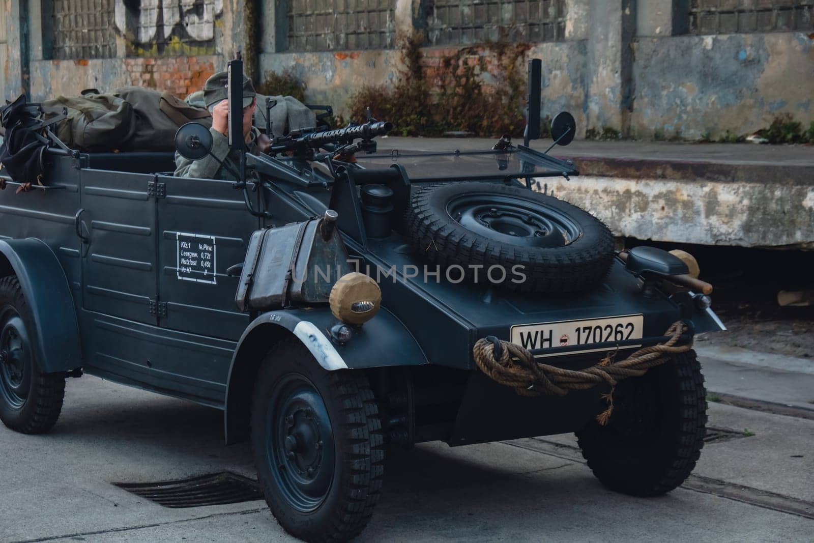 Hel, Poland - August 2022 Military troops marching during 3 May Polish Constitution Day ceremonial patriotic parade. Polish armed forces tanker military parade. Old guns and cars. Feast of Polish Armed Forces Day, American soldiers with US flag on parade Nato Vehicles Military Equipment