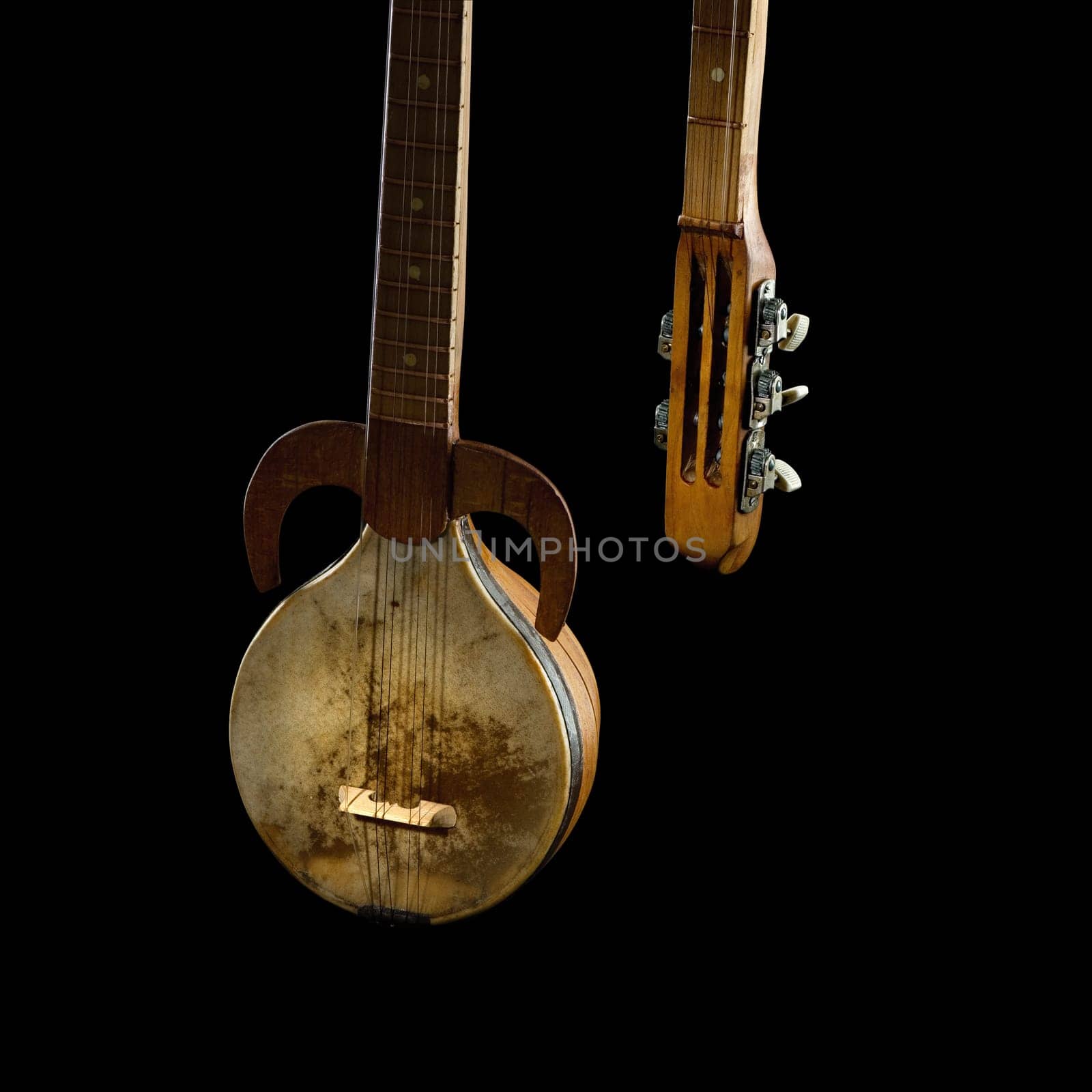 An ancient Asian stringed musical instrument on a black background
