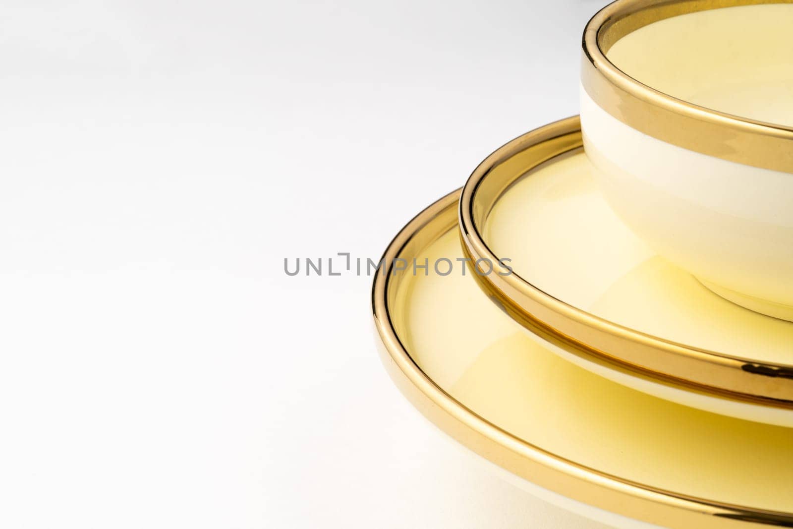 A closeup shot of golden luxury ceramic kitchen utensils on a white background