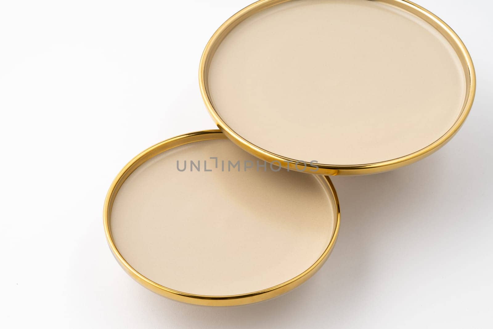 A set of light brown ceramic plate on a white background