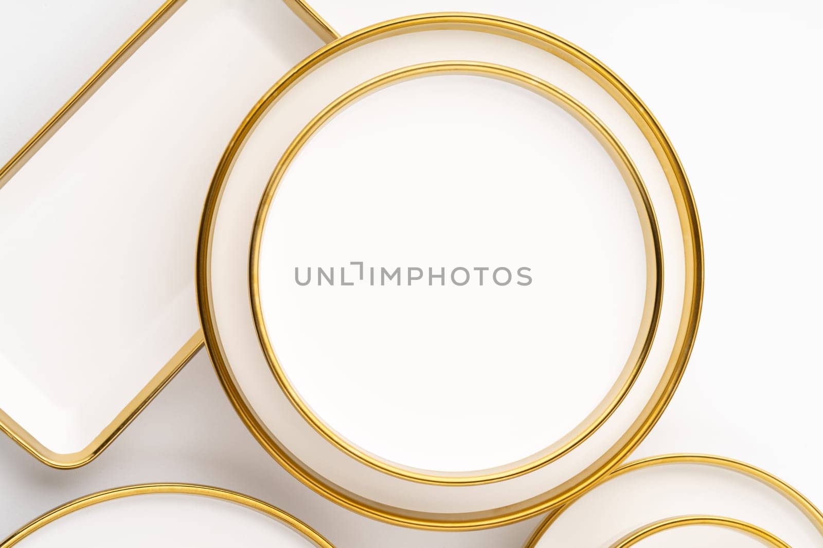 A set of white and brown ceramic plates on a white background. Top view