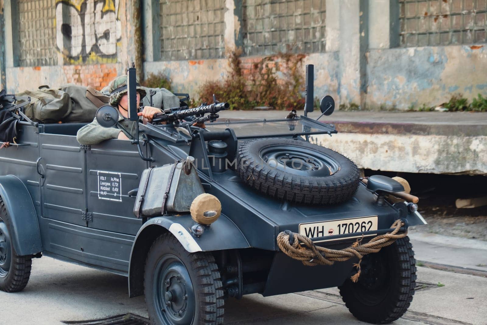 Hel, Poland - August 2022 Military troops marching during 3 May Polish Constitution Day ceremonial patriotic parade. Polish armed forces tanker military parade. Old guns and cars. Feast of Polish Armed Forces Day, American soldiers with US flag on parade Nato Vehicles Military Equipment