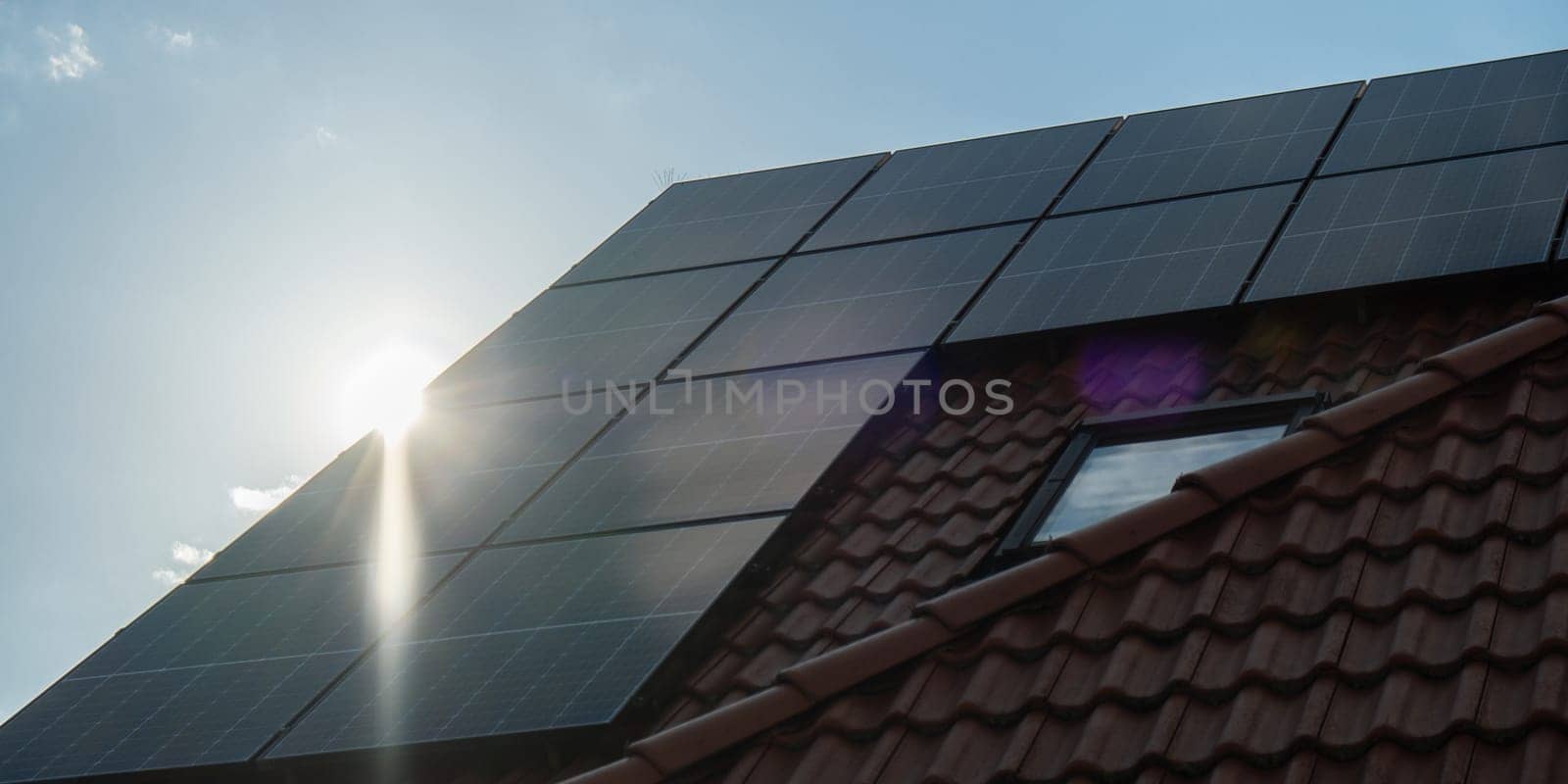 New ecologic house with solar panels Alternative to conventional energy. The battery is charged from a solar cell Advertisement Green energy Sustainable life Renewable alternative energy