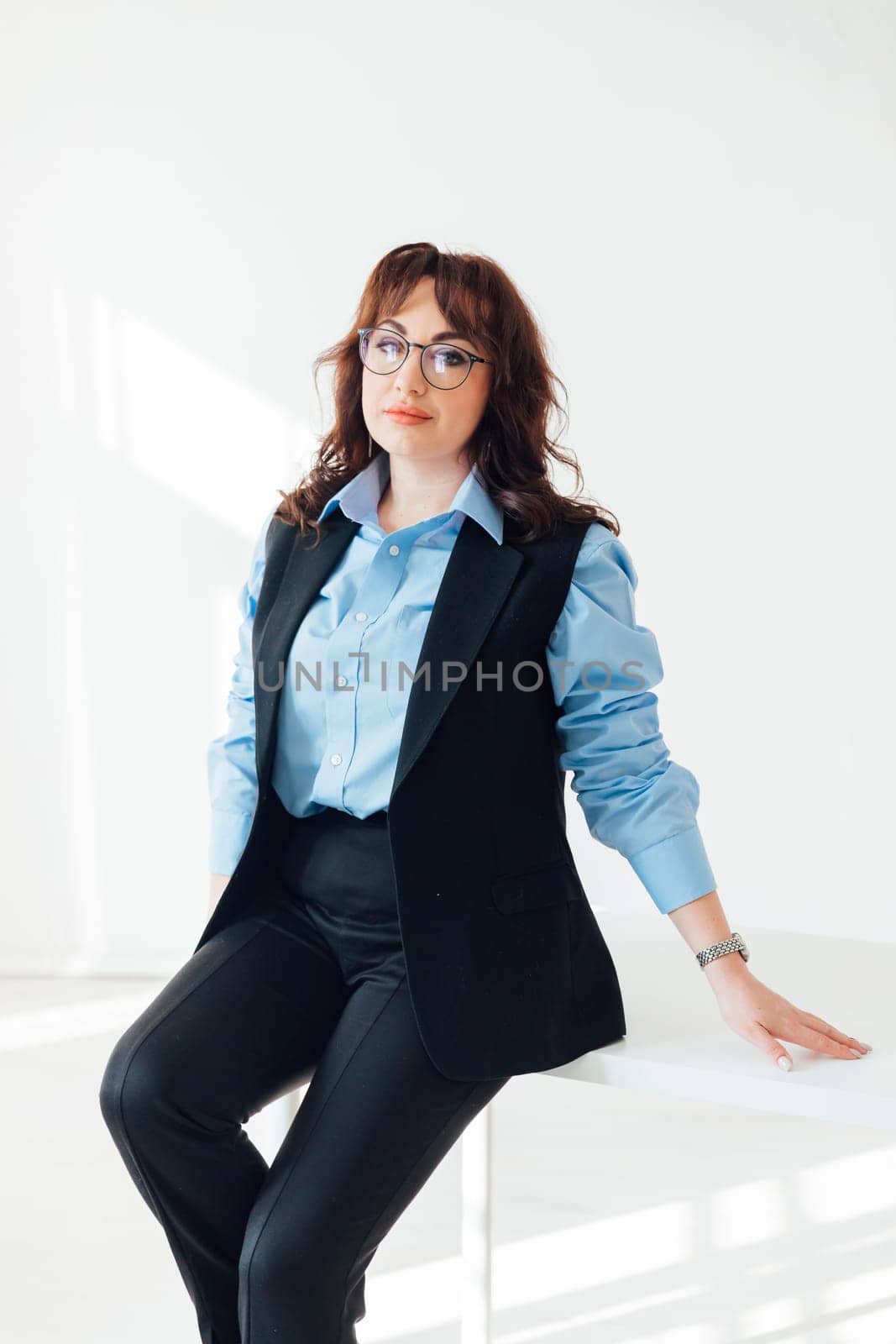 a female teacher with glasses in the classroom on the table lesson school