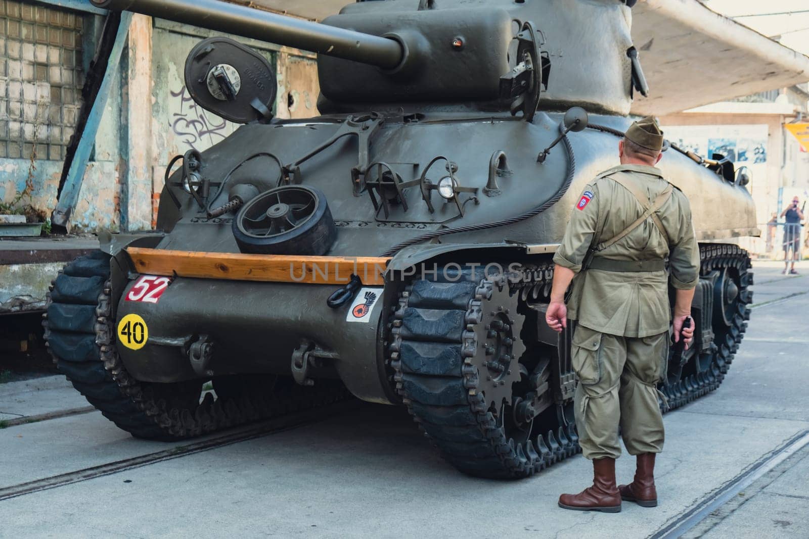 Hel, Poland - August 2022 Military troops marching during 3 May Polish Constitution Day ceremonial patriotic parade. Polish armed forces tanker military parade. Old guns and cars. Feast of Polish Armed Forces Day, American soldiers with US flag on parade Nato Vehicles Military Equipment