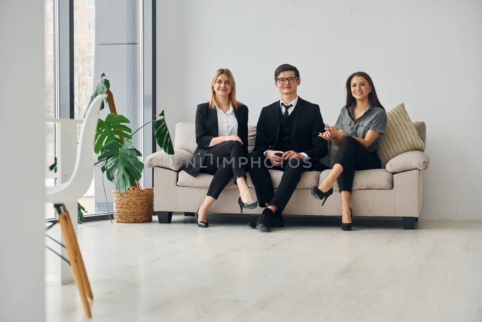 Group of people in official formal clothes that is indoors in the office.