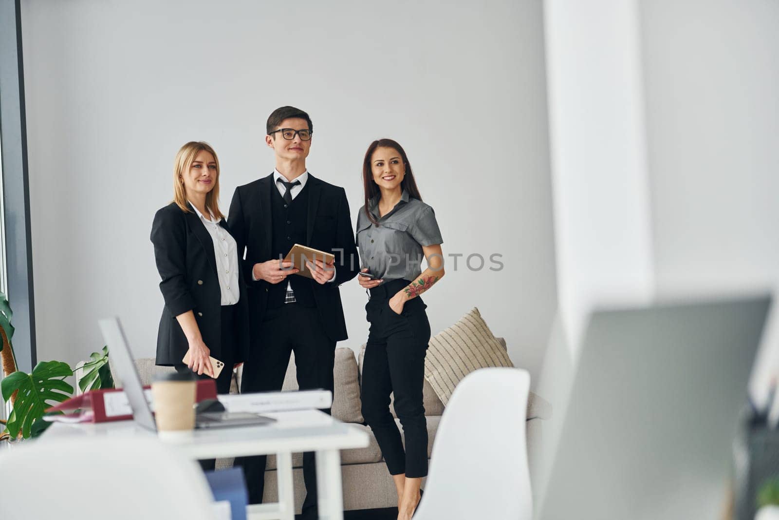 Group of people in official formal clothes that is indoors in the office by Standret