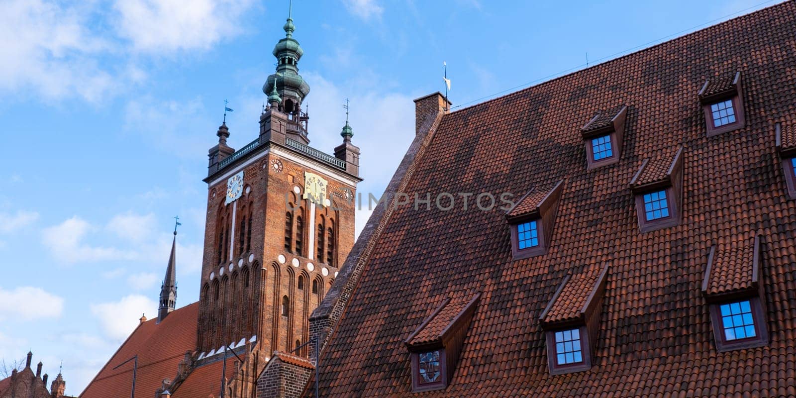 Gothic Church of St. Catherine in Gdansk Ancient architecture of old town in Gdansk Poland. Beautiful and colorful old houses historical part of downtown. Travel destination. Tourist attraction