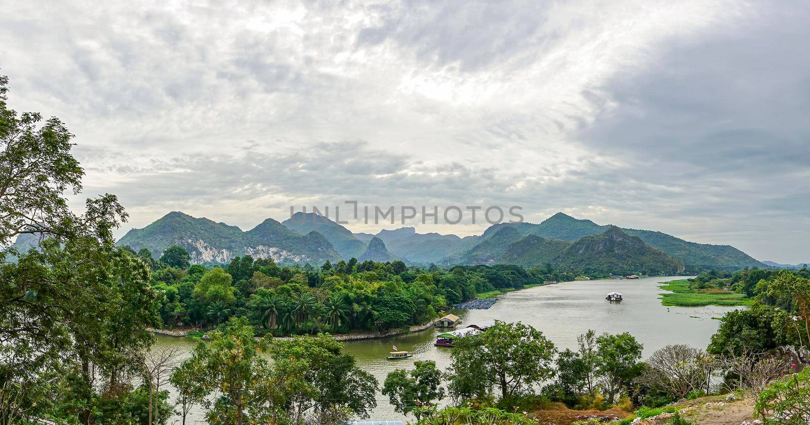 Panorama is views of the River Kwai and the mountains of Kanchanaburi Thailand.