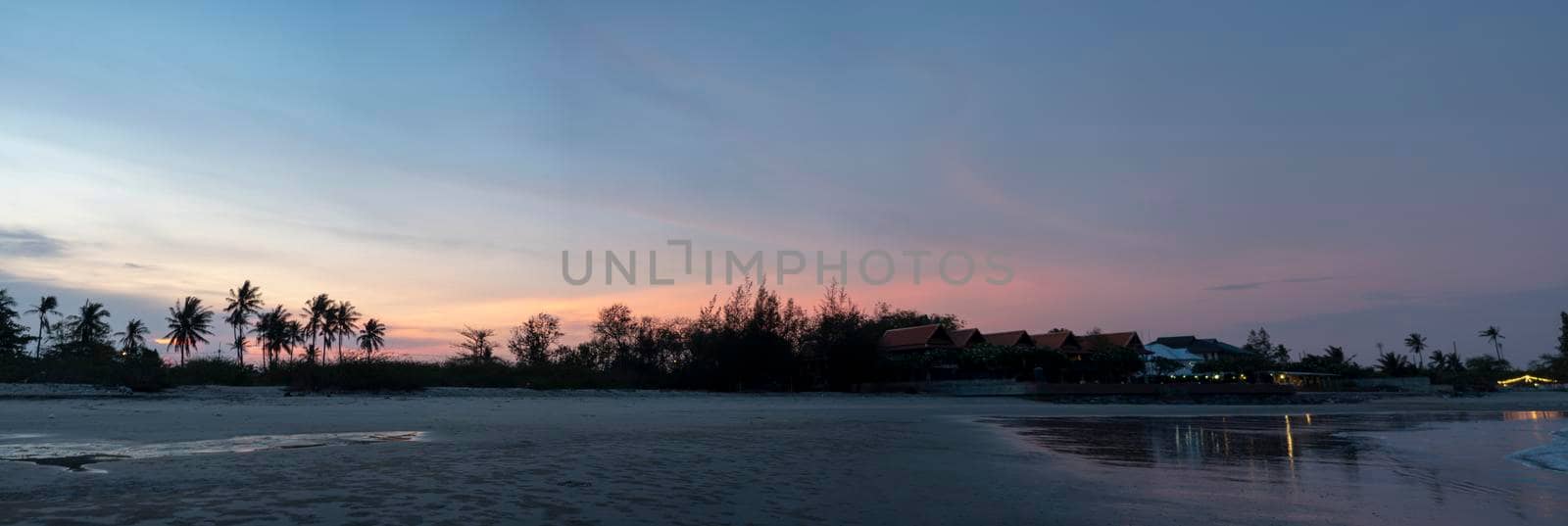 Panorama ,Coconut trees and trees separating the beach "Chao Samran" and the road , Sky in the evening after sunset	