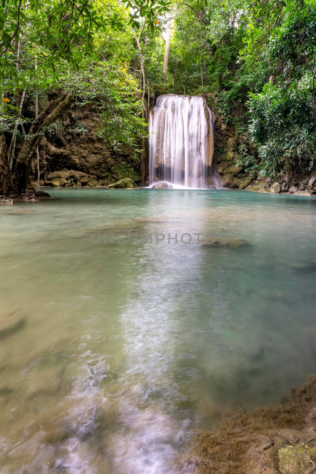 Clean green emerald water from the waterfall Surrounded by small trees - large trees,  green colour, Erawan waterfall, Kanchanaburi province, Thailand