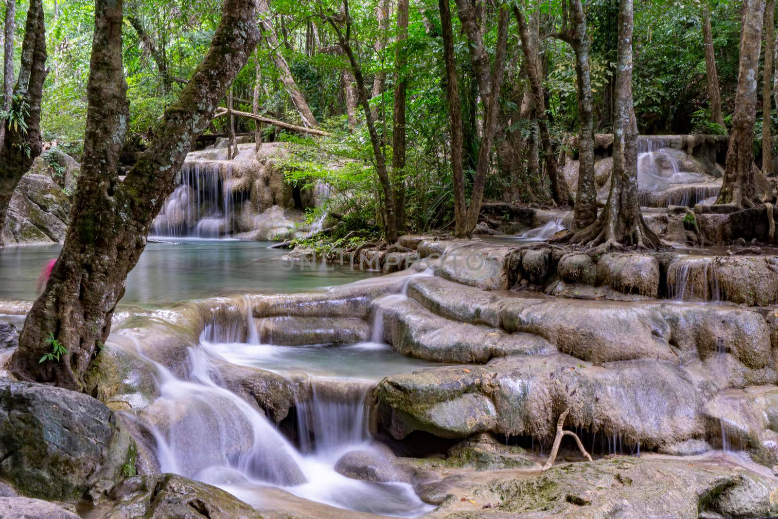 Clean green emerald water from the waterfall Surrounded by small trees - large trees,  green colour, Erawan waterfall, Kanchanaburi province, Thailand
