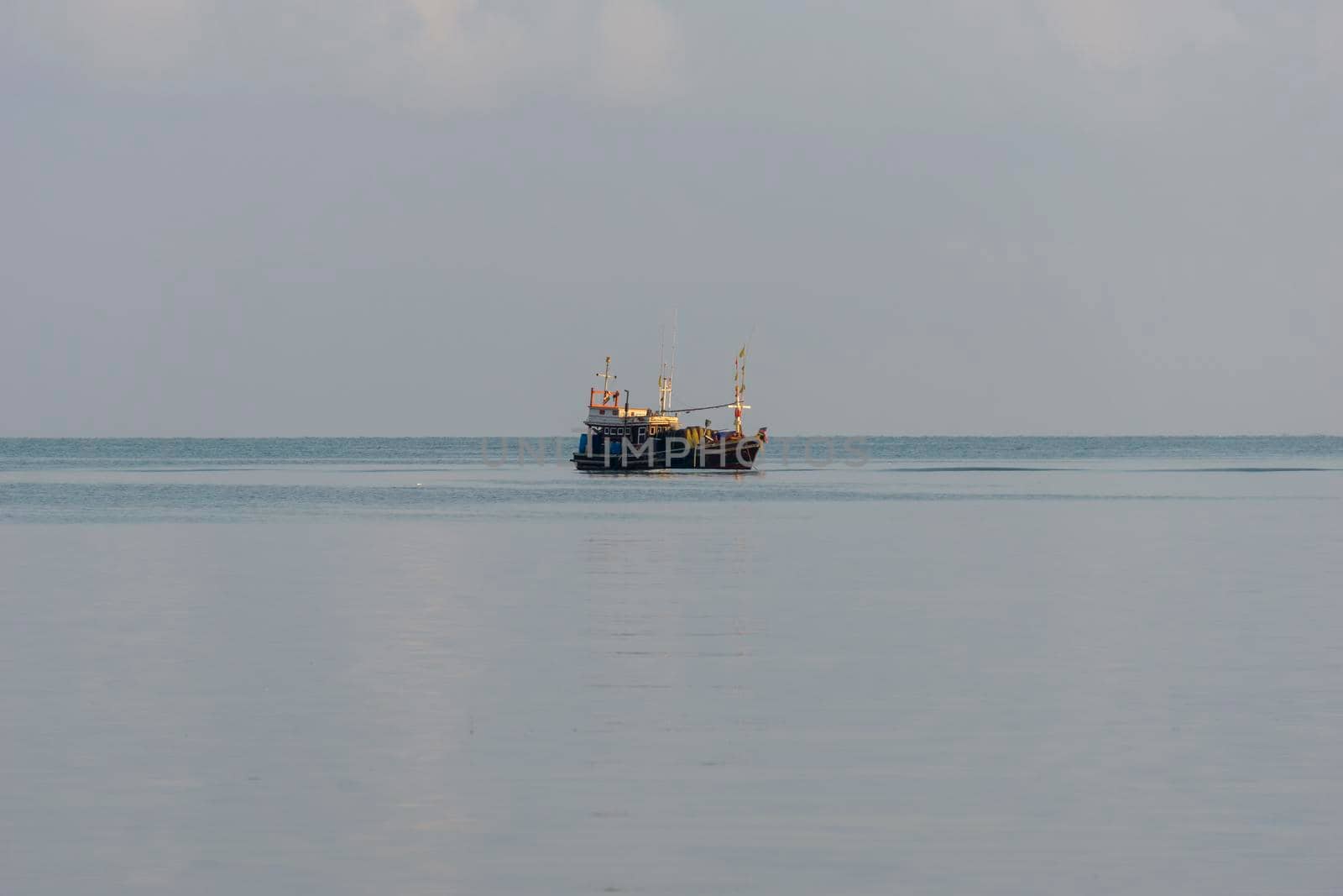 A small fishing boat is anchored. Stop back from Fishing near the coast