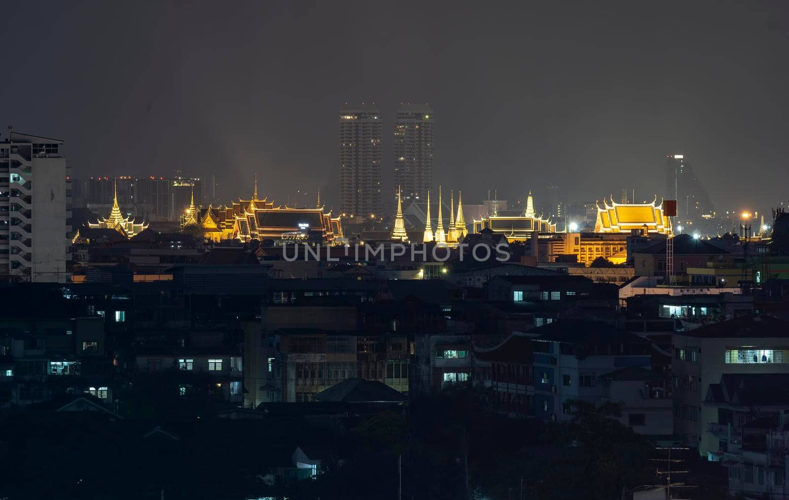 The capital city of Thailand is decorated with bright lights at night. Visible from a distance