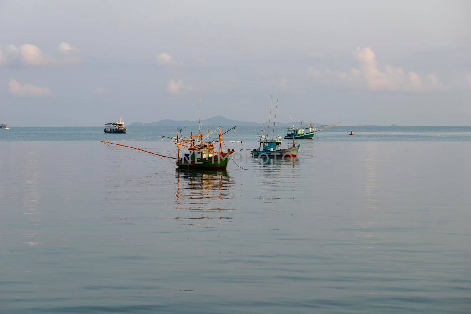 A small fishing boat is anchored. Stop back from Fishing near the coast