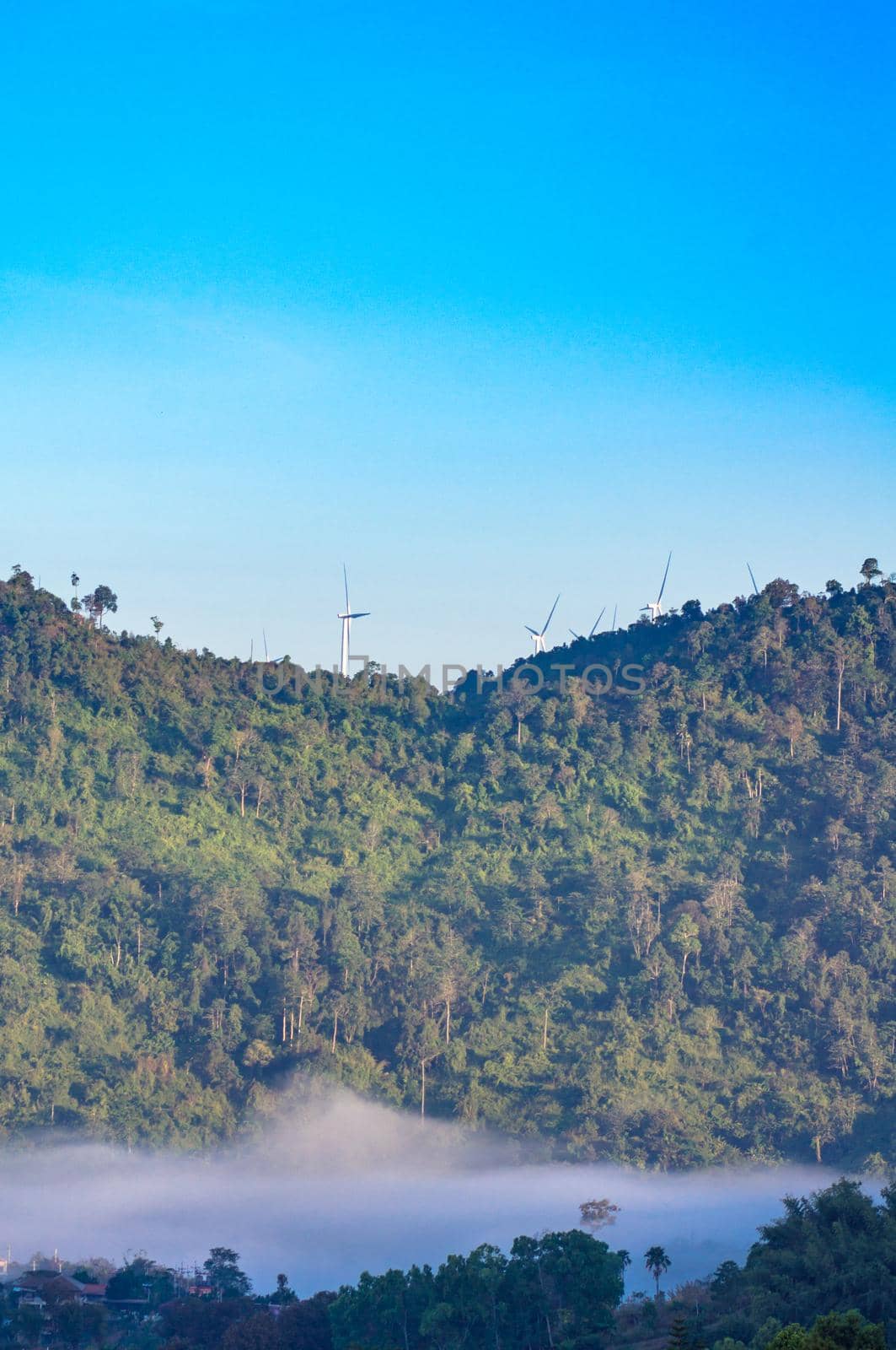 Wind turbine at the mountain and the mist.