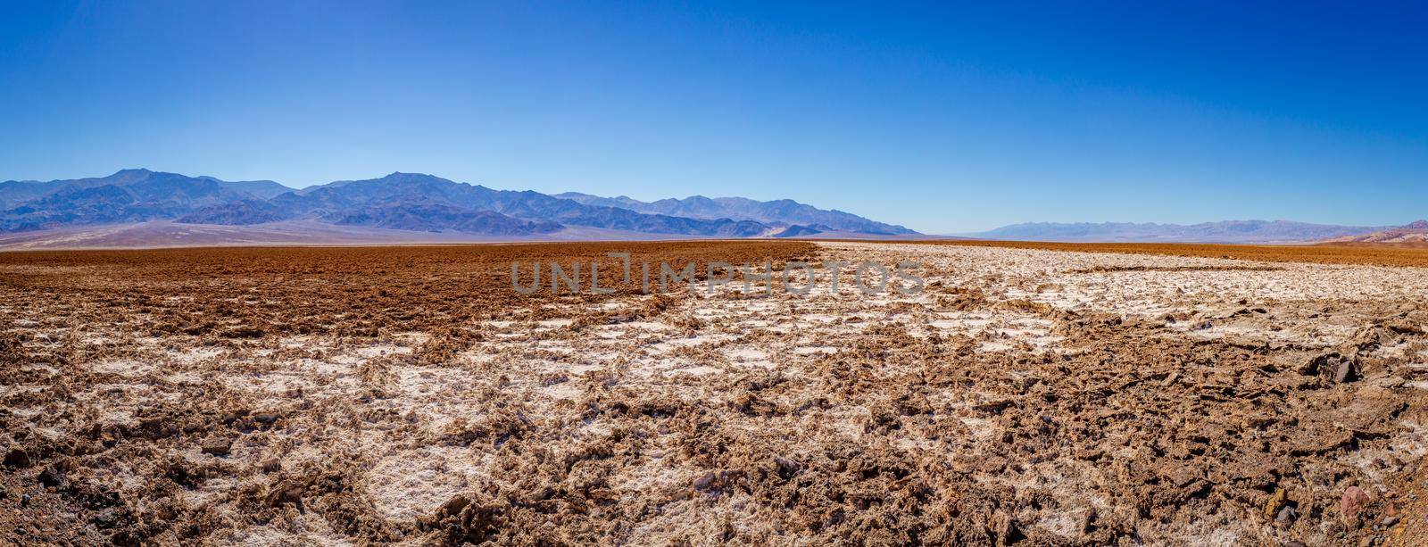 Devil's golf course in Death Valley National Park, with rough surface some covered by white salt