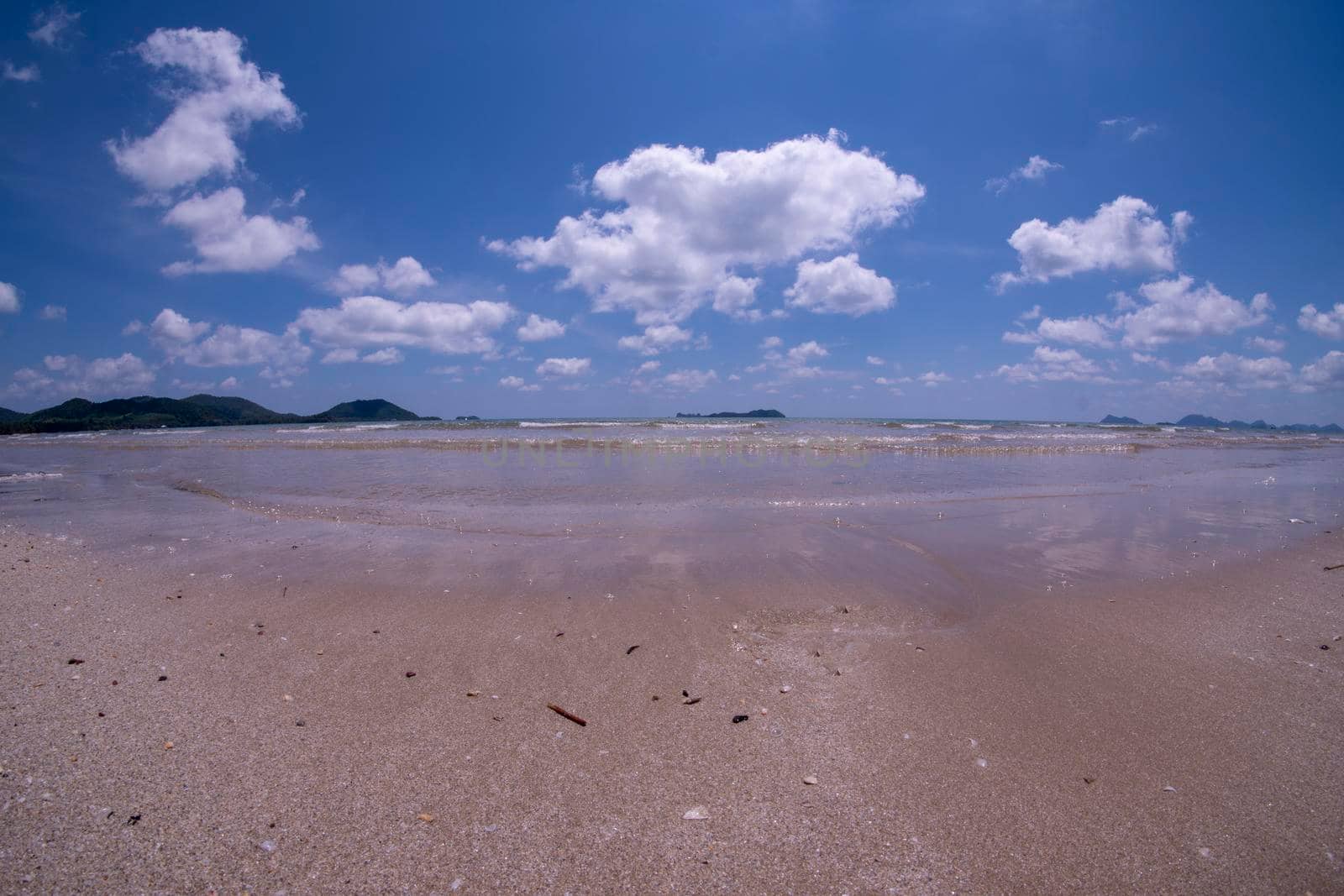Daytime beach wide angle. Sairee Beach, March 2019. Fluffy white clouds and blue skies.