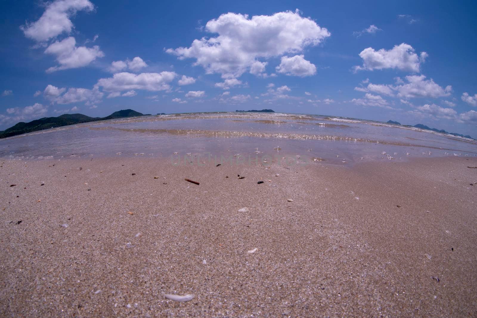 Daytime beach wide angle. Sairee Beach, March 2019. Fluffy white clouds and blue skies.