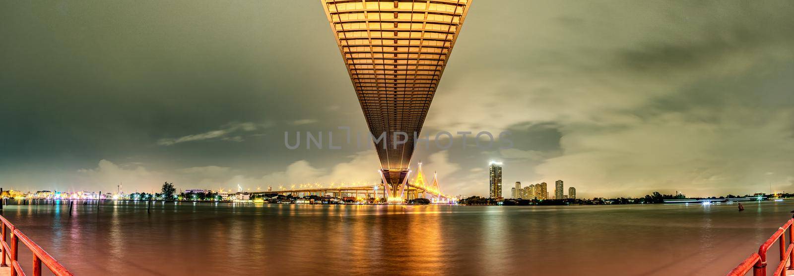 Panorama Oreng led light under the bridge over the river On a cloudy day in the sky. Bhumibol Bridge, Samut Prakan, Thailand