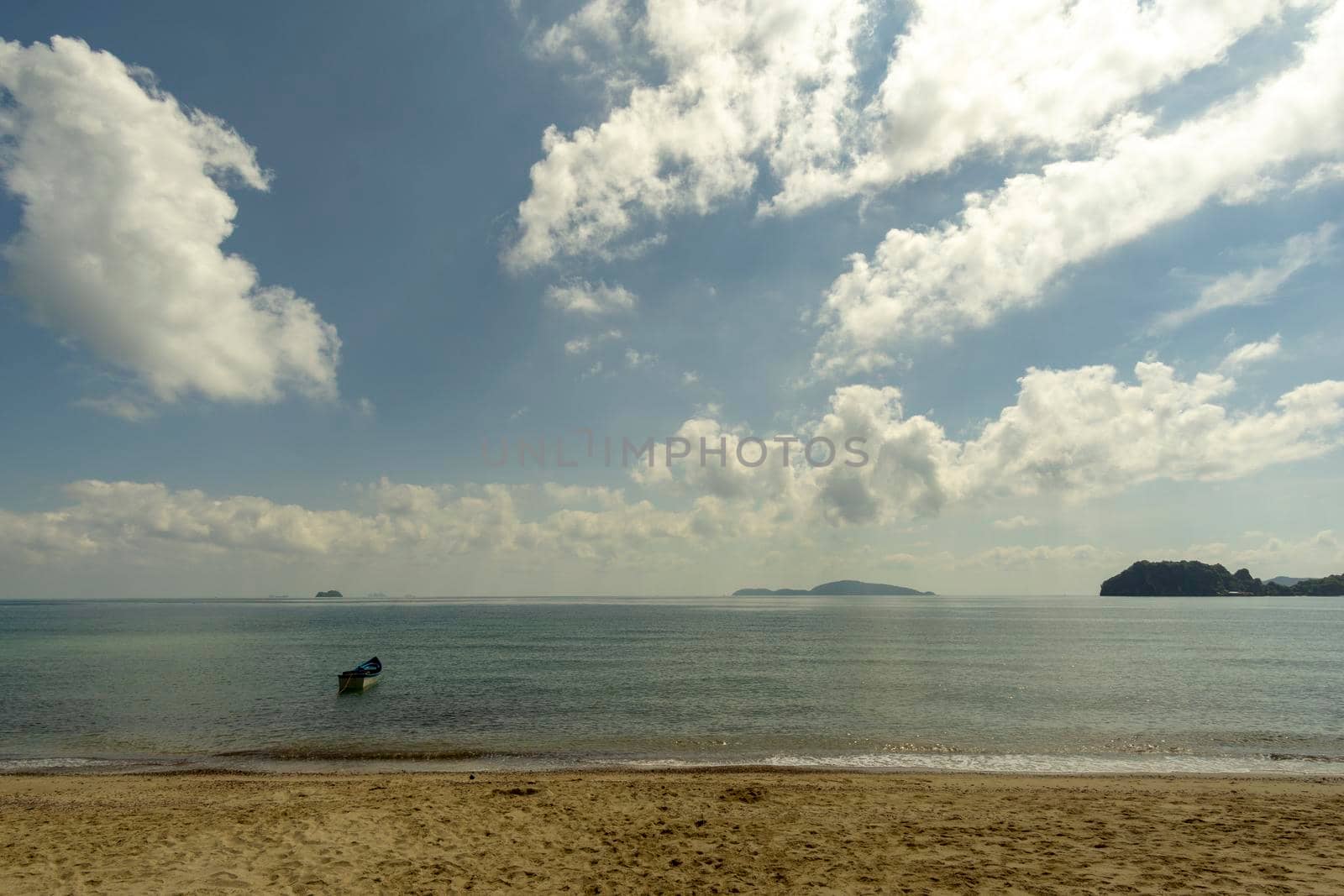 Sea atmosphere at Sairee Beach, Chumphon Province, March 2019.​The sea and the beach at noon. The bright sky, the clouds are white.