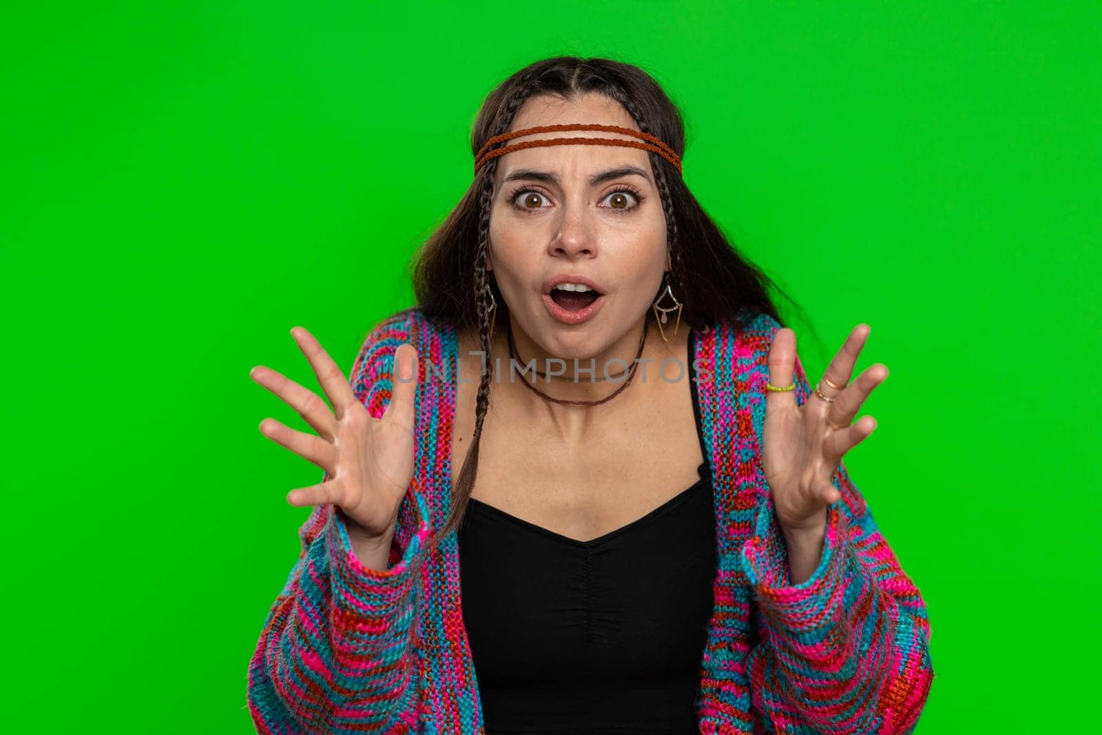 Oh my God, Wow. Excited amazed winner woman raising hands in surprise looking at camera with big eyes, shocked by sudden victory. Happy hippie girl isolated on chroma key background, green screen