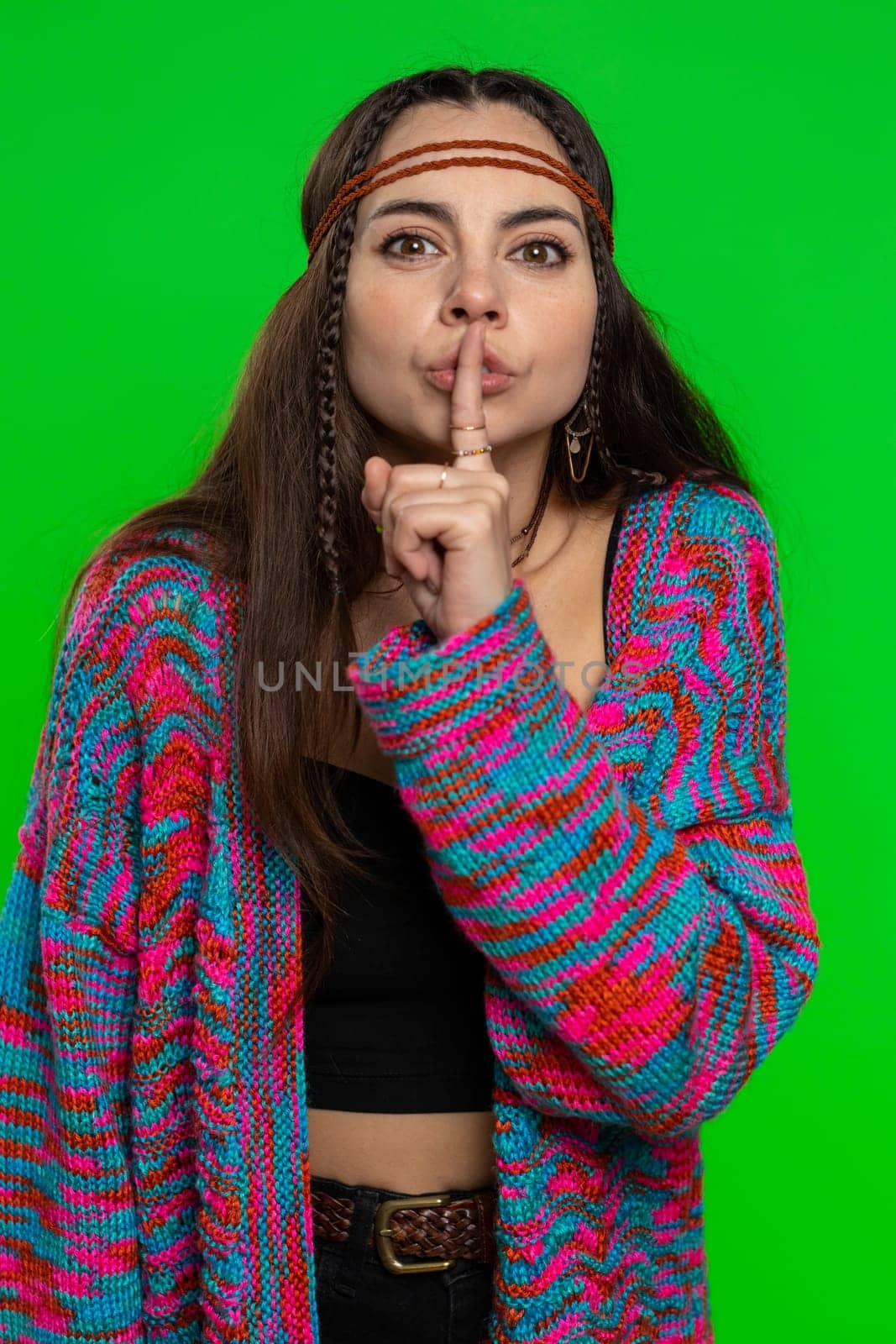 Shh be quiet please. Young woman presses index finger to lips makes silence gesture sign do not tells secret, stop gossip. Pretty hippie girl isolated alone on chroma key background, green screen