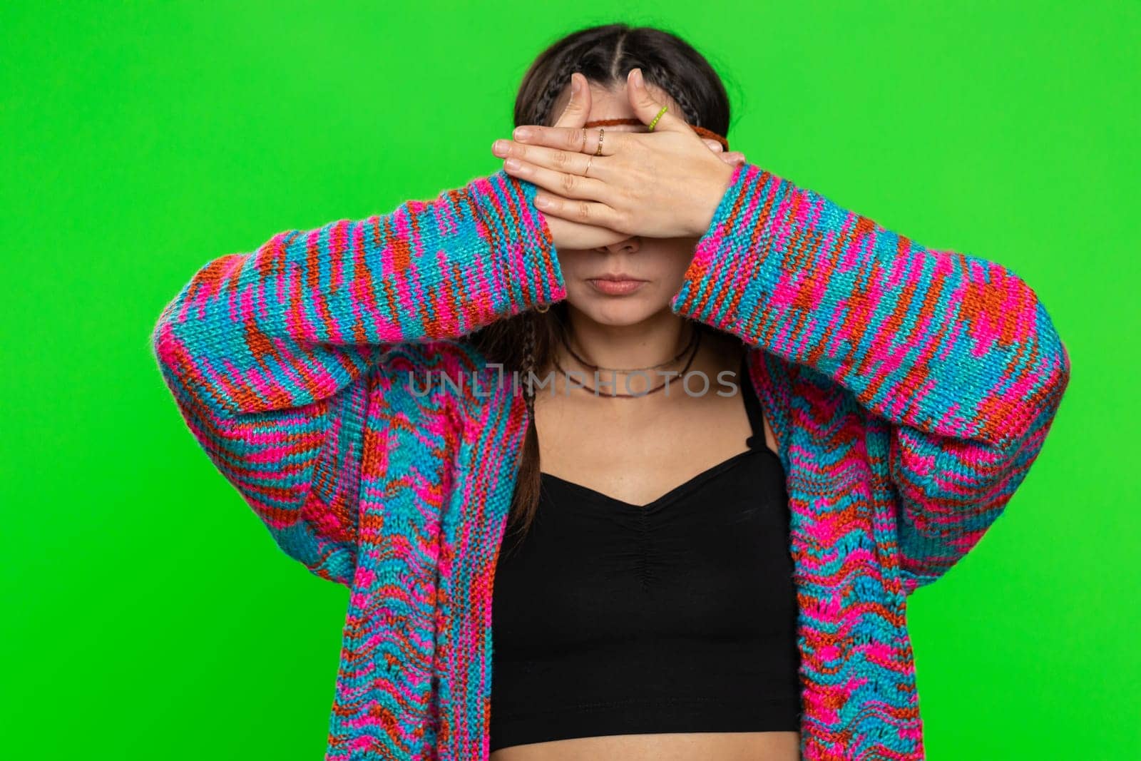 Dont want to look at this, awful. Afraid woman closing eyes with hand showing stop gesture, confused shy scared to watch. Young girl isolated on chroma key background, green screen. People lifestyles