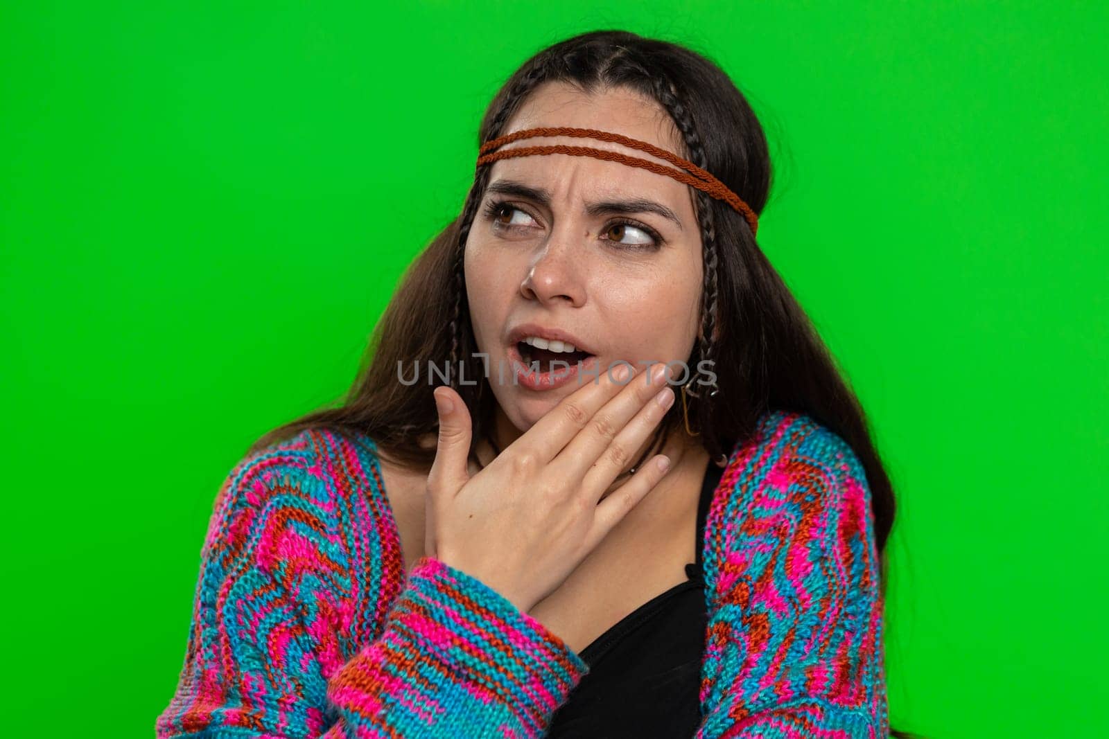 Young woman touching sore cheek suffering from toothache cavities or gingivitis waiting for dentist appointment gums disease. Girl indoors studio shot isolated on chroma key background, green screen