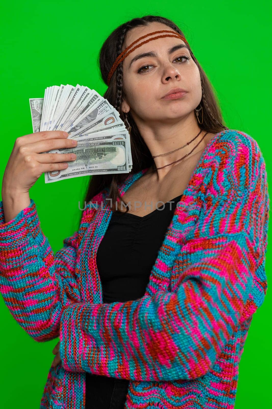 Rich pleased boss young woman waving money dollar cash banknotes bills like a fan, success business career, lottery winner, big income, wealth. Hippie girl isolated on green chroma key background