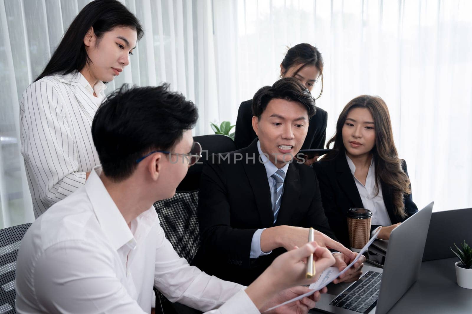 Office worker and manager analyze financial report paper in harmony workplace. by biancoblue