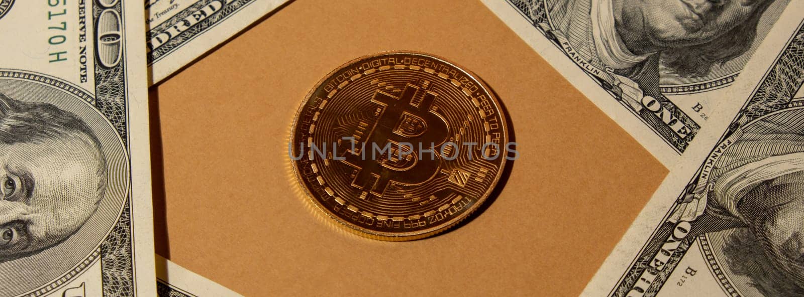 Bitcoin gold coin on bills of 100 dollars American currency. Bitcoin mining trading concept. BTC golden money. Worldwide virtual internet Cryptocurrency or crypto digital payment system. Digital coin money farm in digital cyberspace