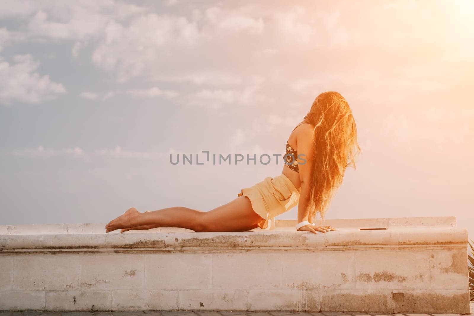 Woman park yoga. Side view of free calm bliss satisfied woman with long hair standing in morning park with yoga position against of sky by the sea. Healthy lifestyle outdoors in park, fitness concept