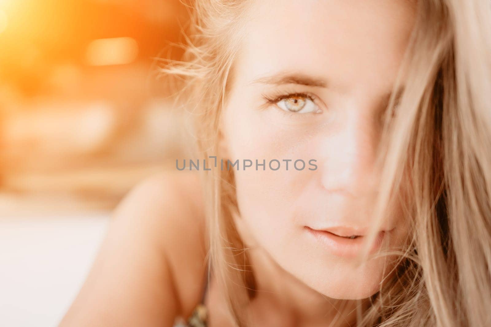 Happy woman portrait in cafe. Boho chic fashion style. Outdoor photo of young happy woman with long hair, sunny weather outdoors sitting in modern cafe