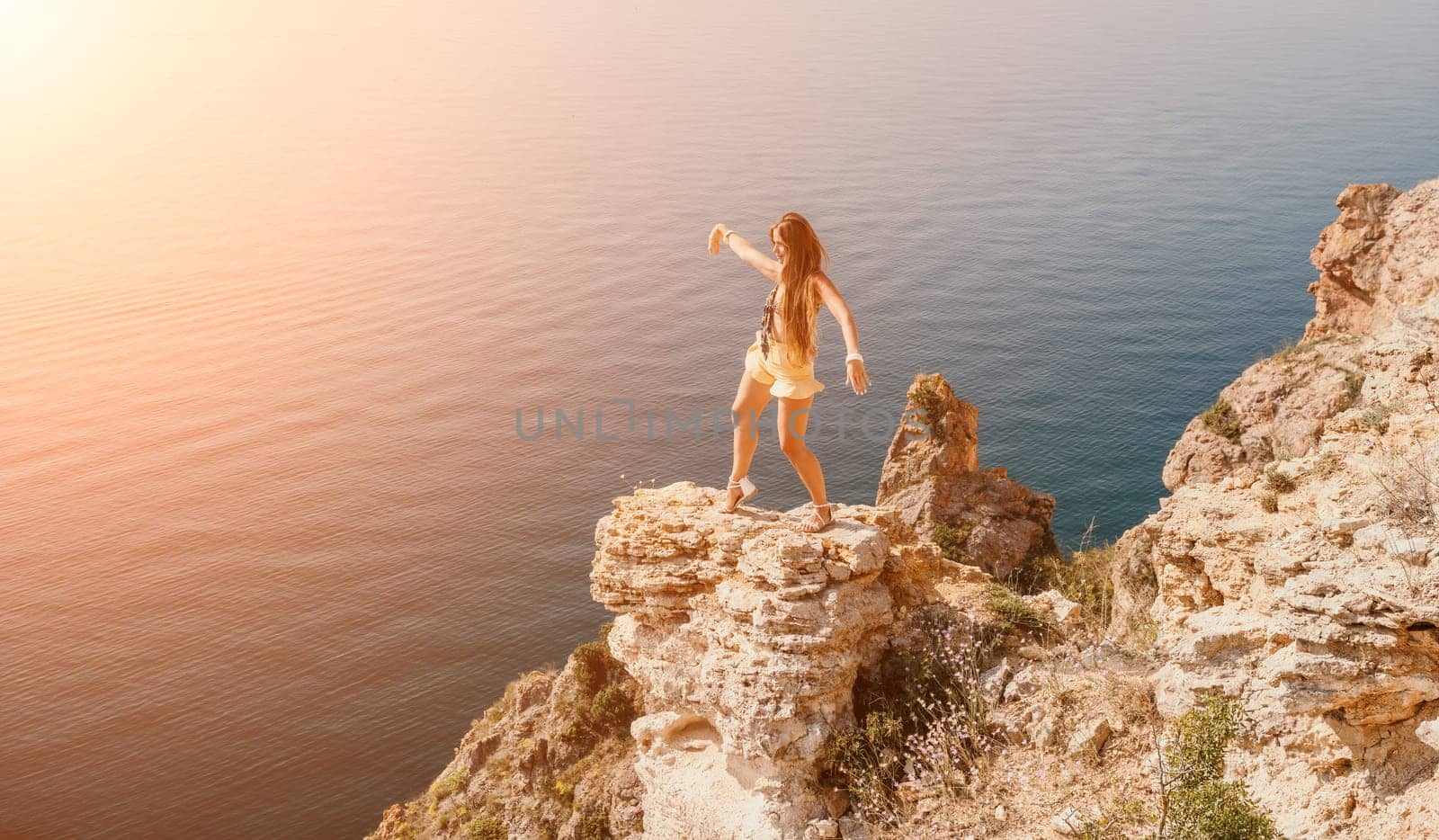 Woman travel sea. Happy tourist enjoy taking picture outdoors for memories. Woman traveler looks at the edge of the cliff on the sea bay of mountains, sharing travel adventure journey by panophotograph