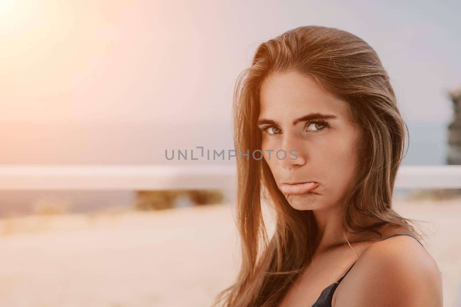 Happy woman portrait in cafe. Boho chic fashion style. Outdoor photo of young happy woman with long hair, sunny weather outdoors sitting in modern cafe. by panophotograph